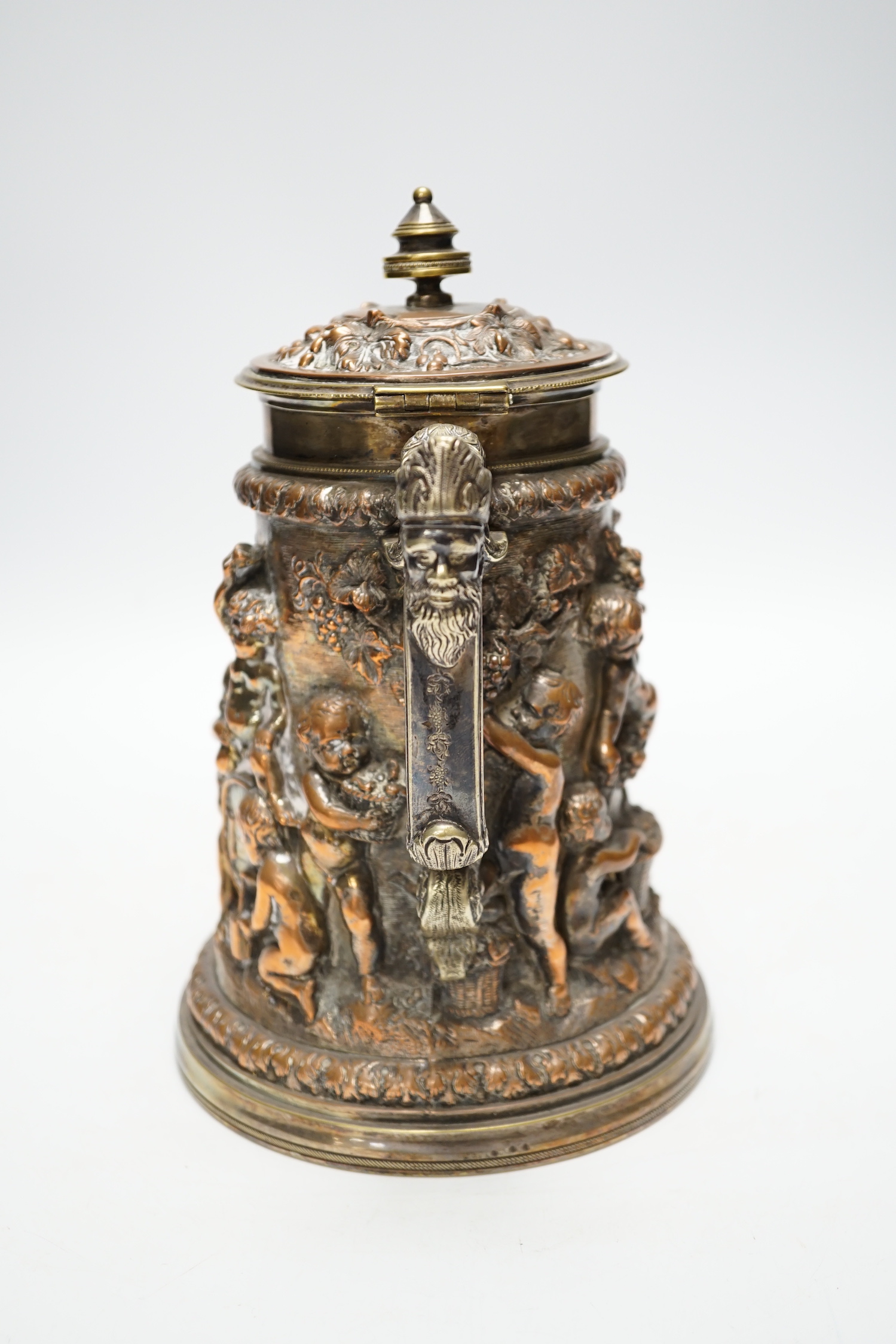 A Victorian electrotype relief putti jug with hinged cover. 24cm high